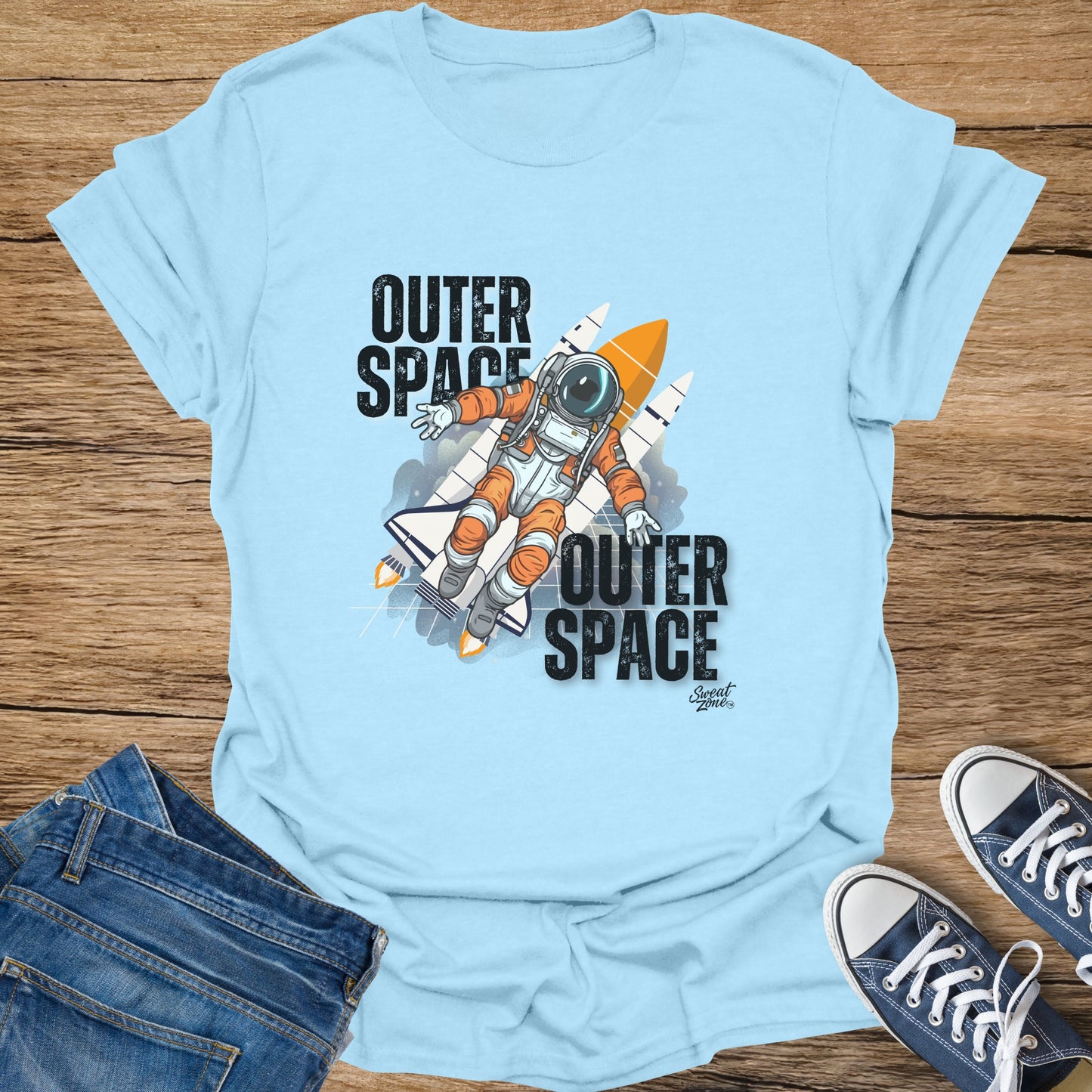 Light blue t-shirt with astronaut and rocket graphic, says "Outer Space".