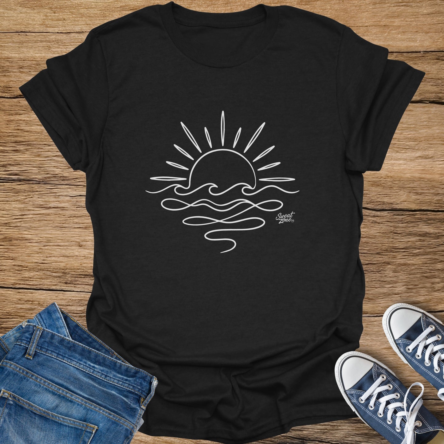 Black t-shirt with white line drawing of a sun setting over waves, and "Sweat Zone" logo.