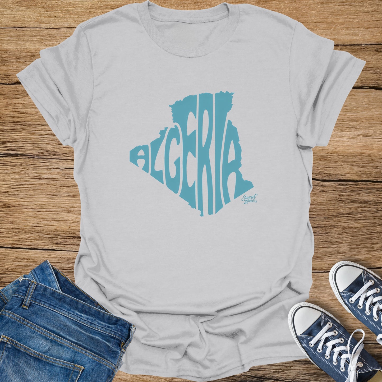 Light grey t-shirt with teal Algeria map outline filled with text.