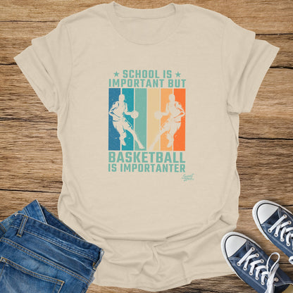 T-shirt with text "SCHOOL IS IMPORTANT BUT BASKETBALL IS IMPORTANTER" and basketball players.