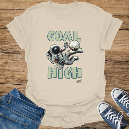 Astronaut playing soccer with moon, text "GOAL HIGH".