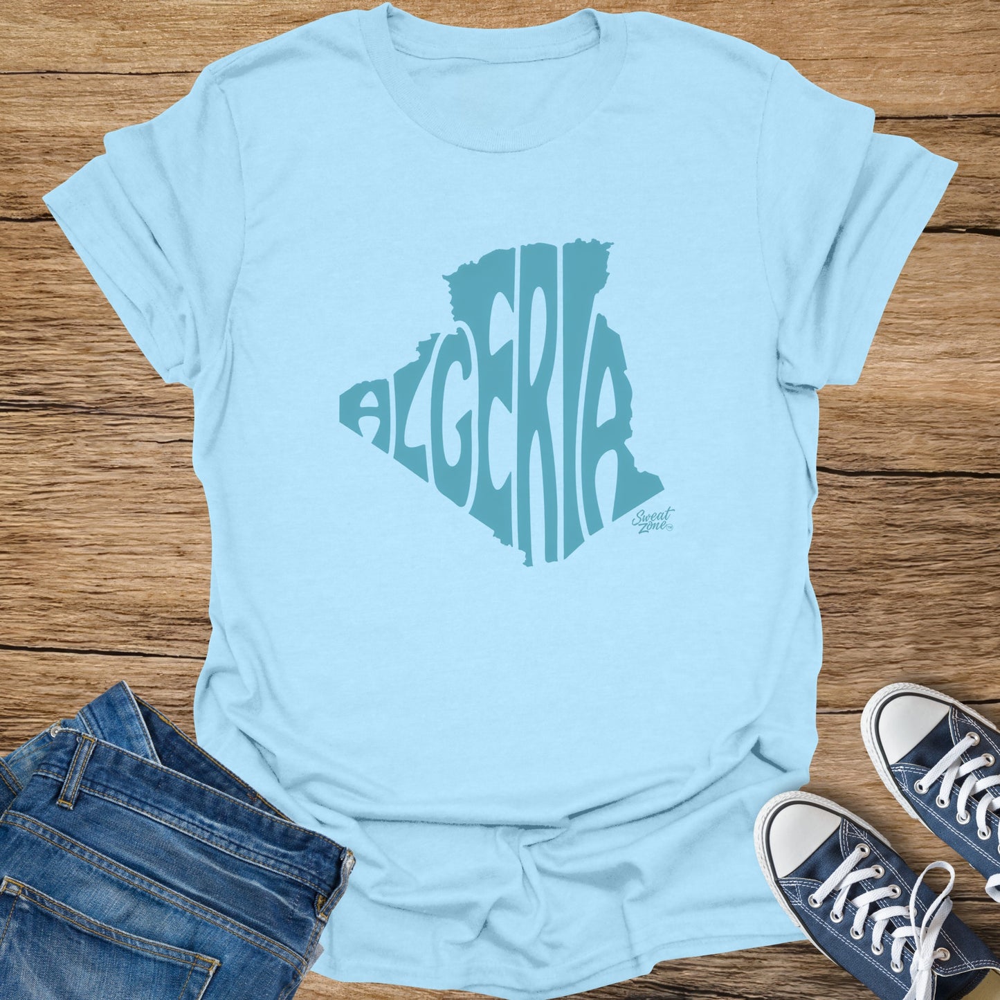 Light blue t-shirt with Algeria map graphic and "Sweat Zone" logo.