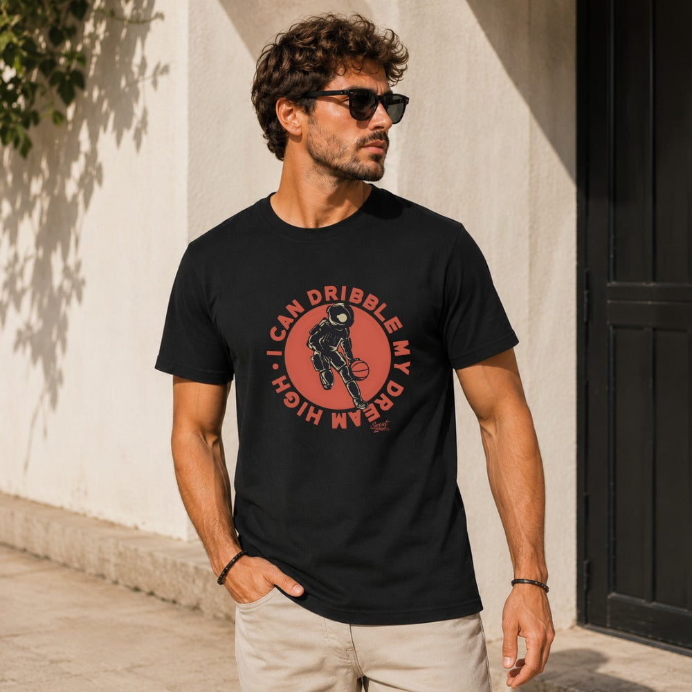 Black t-shirt with "I CAN DRIBBLE MY DREAM HIGH" graphic of an astronaut dribbling a basketball.