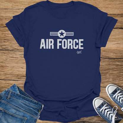 Navy t-shirt with distressed "AIR FORCE" text and star logo, paired with jeans and sneakers.