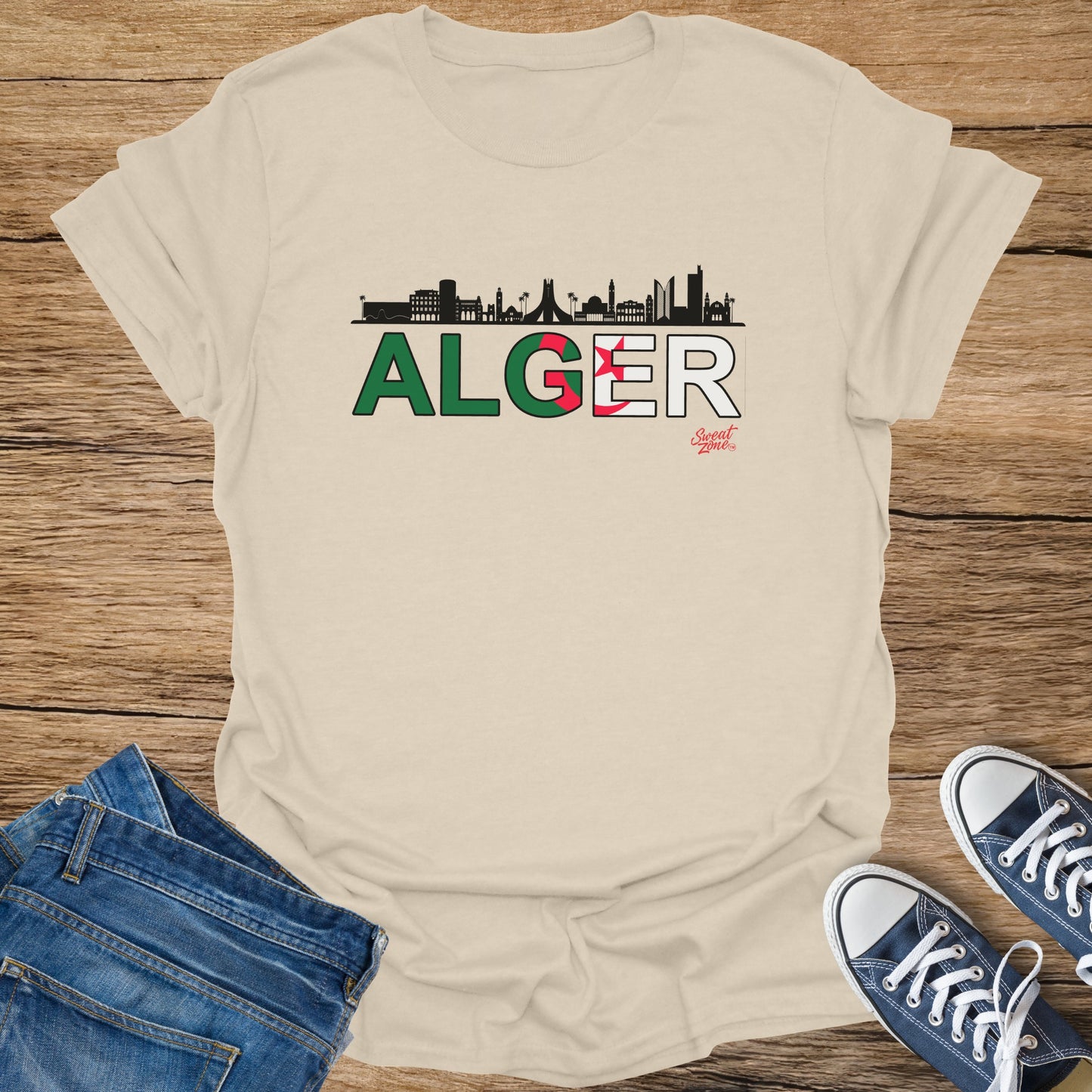 Beige t-shirt with black skyline over "ALGER" and Algerian flag and "Sweat Zone" logo.