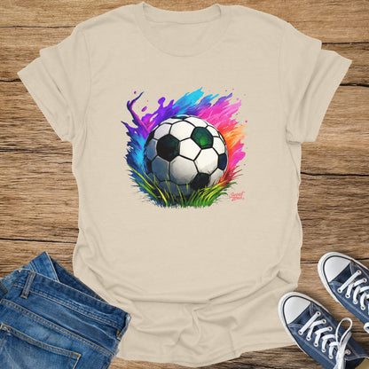 Soccer ball graphic with colorful splashes on a cream t-shirt.