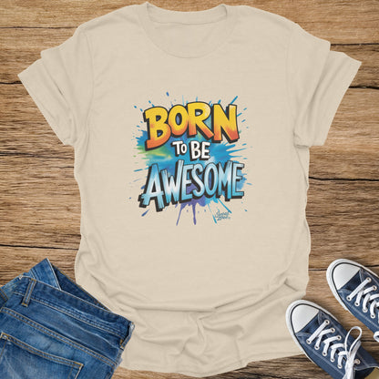 Light-colored t-shirt with "BORN TO BE AWESOME" graphic and watercolor splashes.