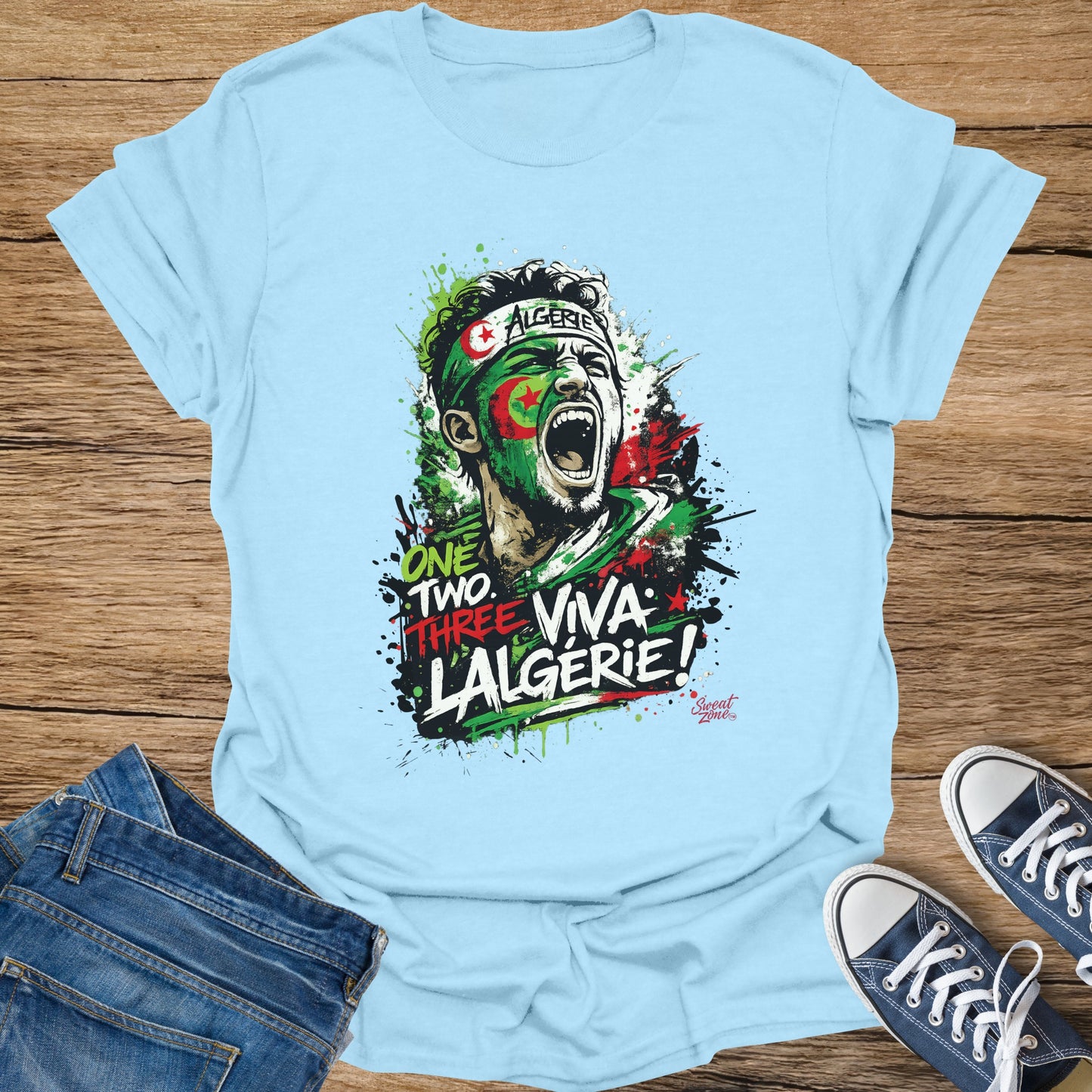 Light blue t-shirt with a distressed graphic of a shouting man wearing Algerian flag face paint.