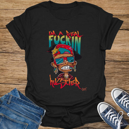 Black t-shirt with cartoon "I'm a fuckin hustler" graphic, blue jeans, and navy sneakers.