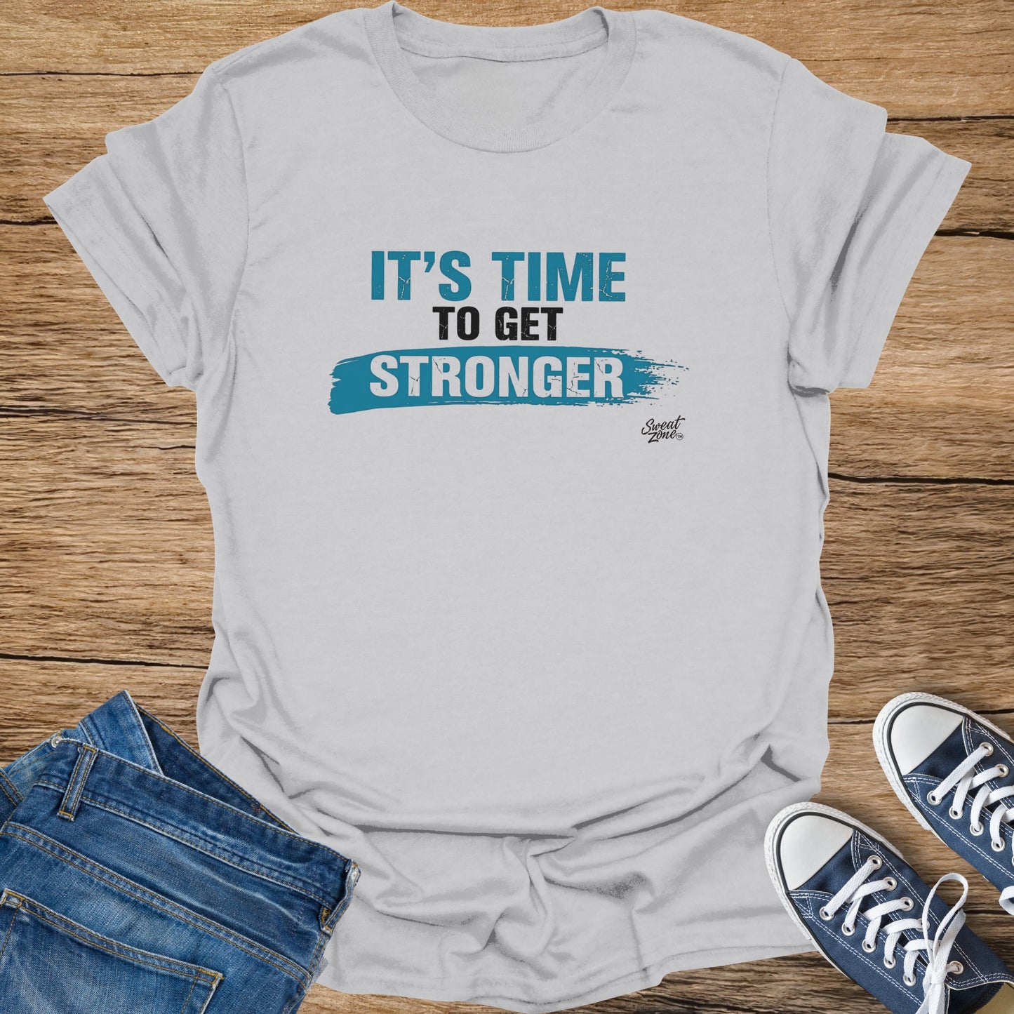 Gray t-shirt with blue text "IT'S TIME TO GET STRONGER" and Sweat Zone logo.
