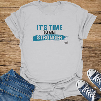 Gray t-shirt with blue text "IT'S TIME TO GET STRONGER" and Sweat Zone logo.