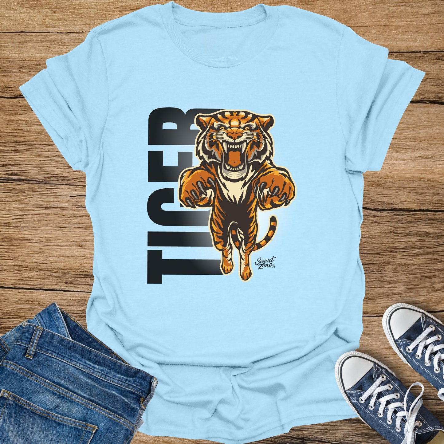 Light blue t-shirt with a roaring tiger graphic and "TIGER" text.