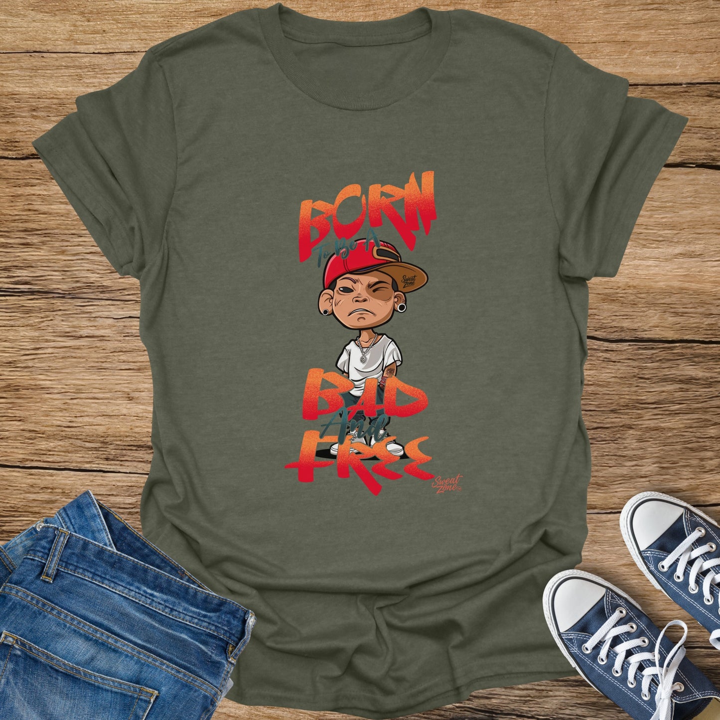 Olive green t-shirt with animated boy graphic and text "BORN TO BE A BAD AND FREE".