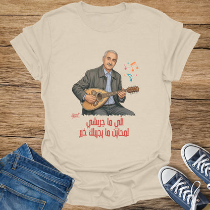 Cream t-shirt with illustration of man playing oud and Arabic text.