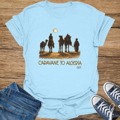 Light blue t-shirt with a desert caravan and "Caravane to Algeria" text.