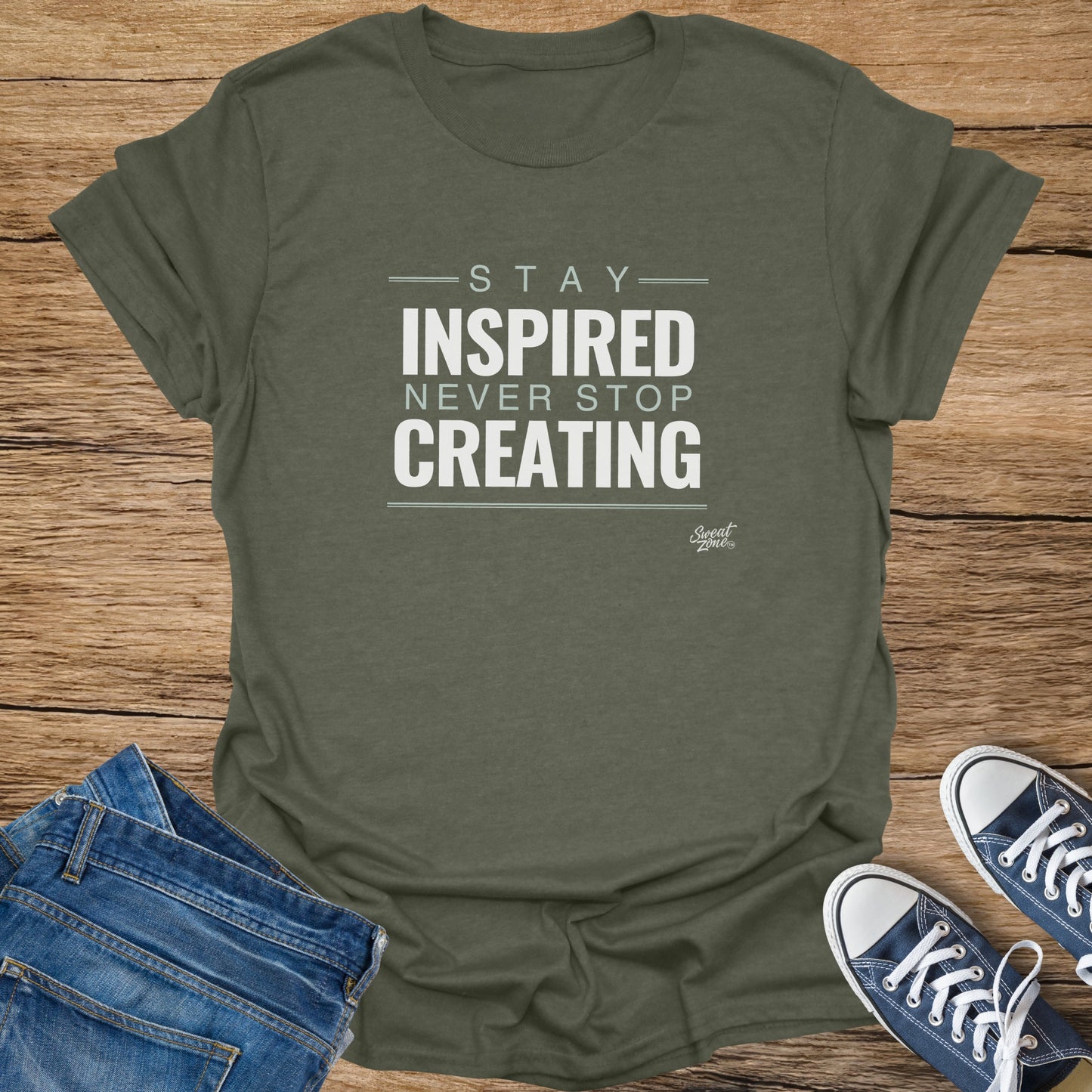 Olive green t-shirt with "Stay Inspired Never Stop Creating" text.