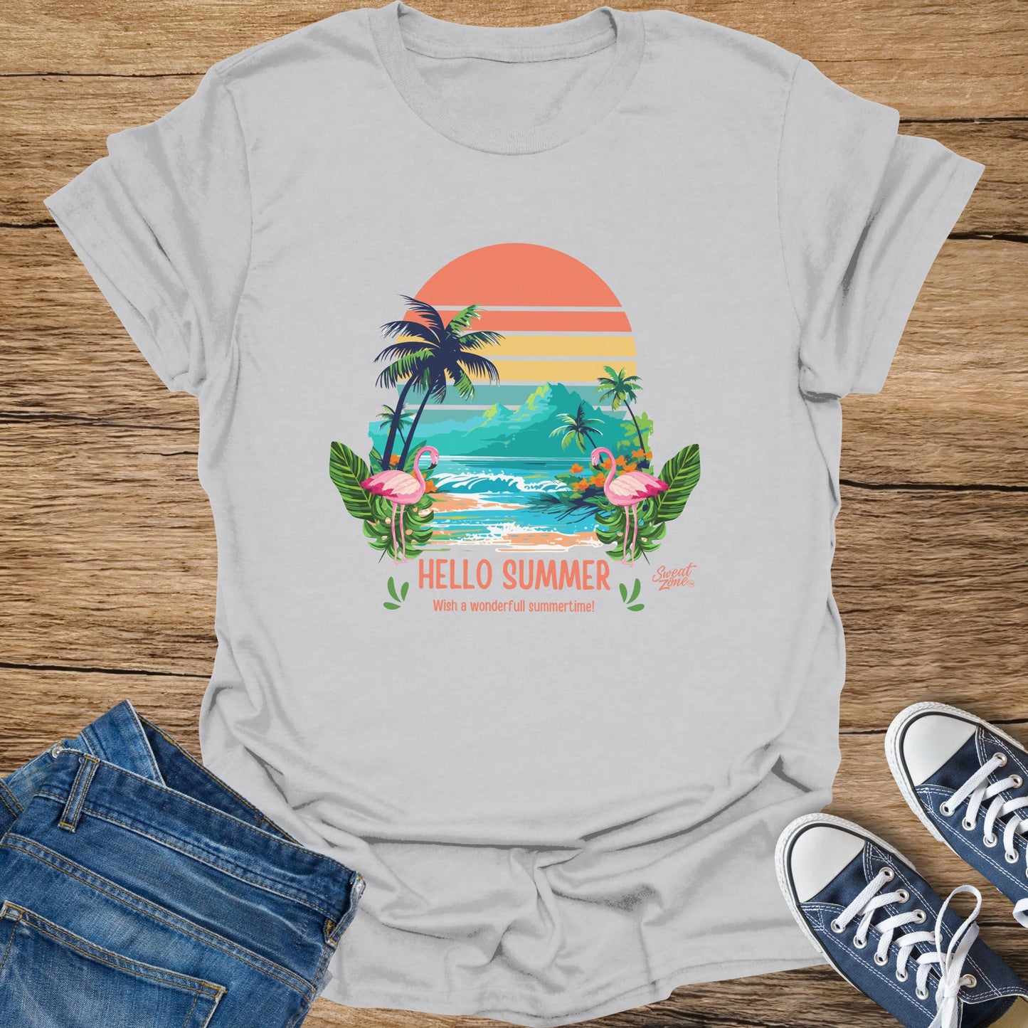 White t-shirt with a tropical sunset graphic, flamingos, palm trees, and text.