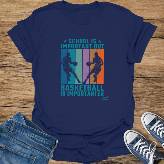 Navy t-shirt with "School is important but basketball is importanter" graphic.
