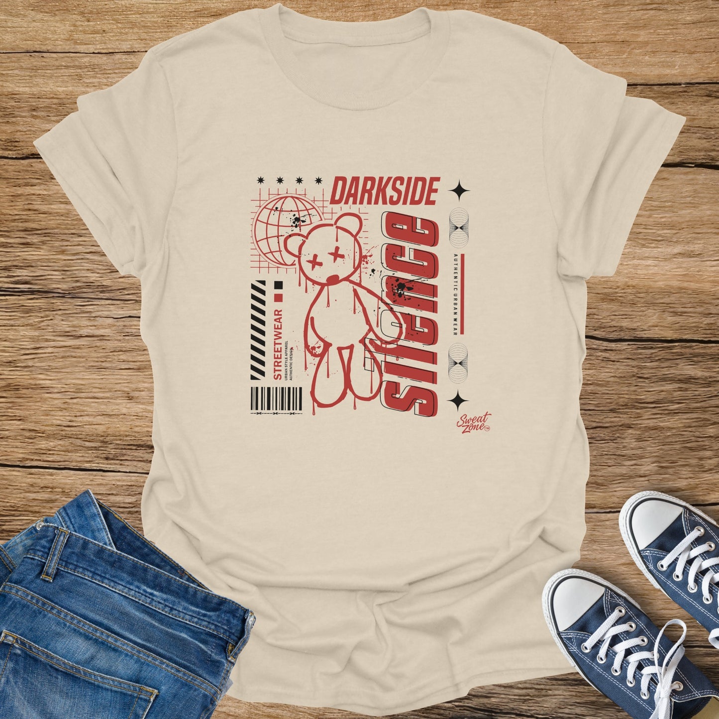 Cream t-shirt with red graphic of a teddy bear, globe, and text "DARK SIDE" and "SACRIFICE".