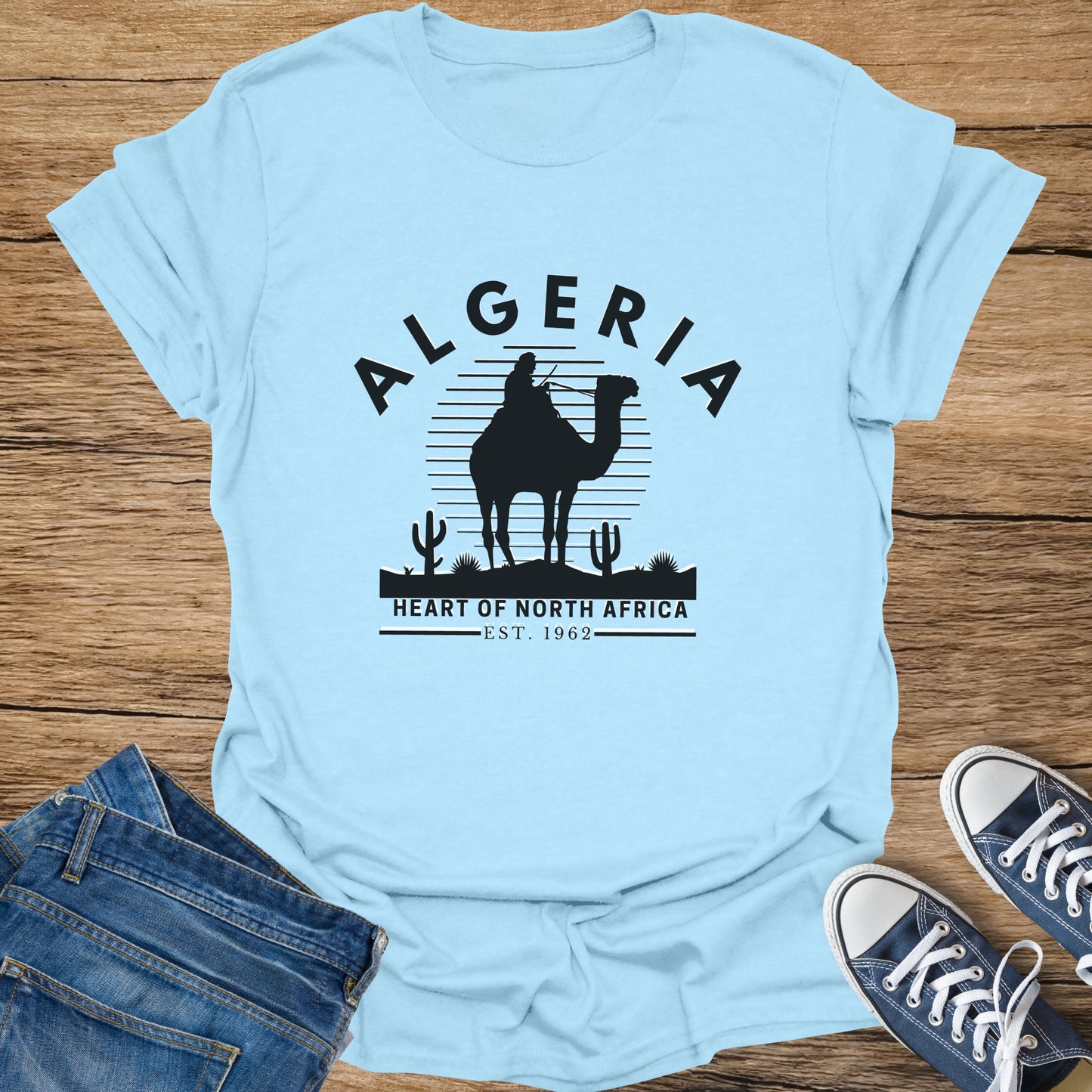 Light blue t-shirt with black camel silhouette, Algeria text, and "Heart of North Africa" graphic.