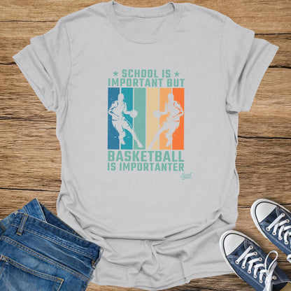 White t-shirt with "SCHOOL IS IMPORTANT BUT BASKETBALL IS IMPORTANTER" graphic.