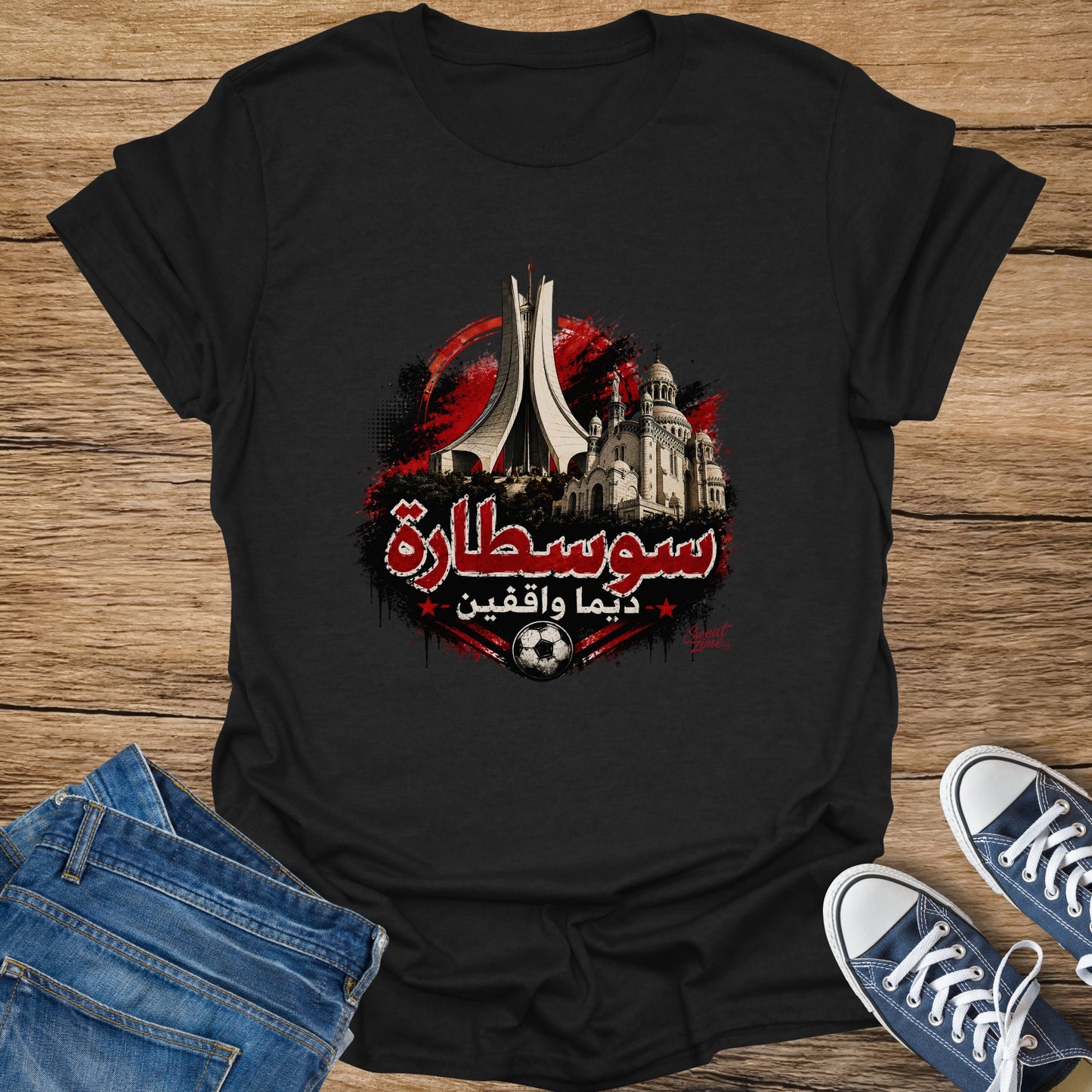 Black t-shirt with Arabic text, landmarks, and a soccer ball graphic.
