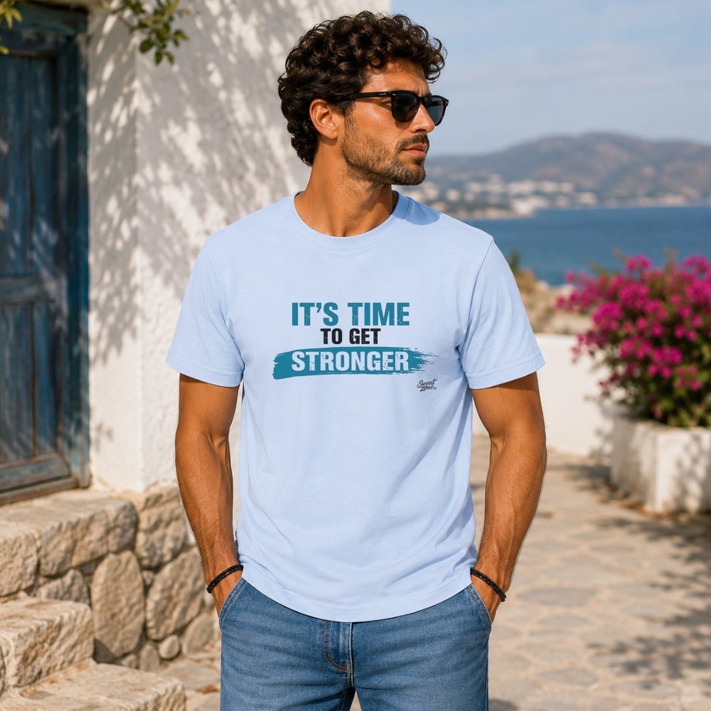 Light blue t-shirt with "IT'S TIME TO GET STRONGER" graphic and a handwritten logo.
