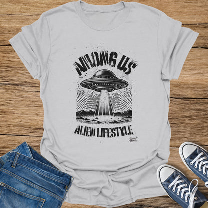 White t-shirt graphic: "Among Us Alien Lifestyle" with a UFO beaming light.