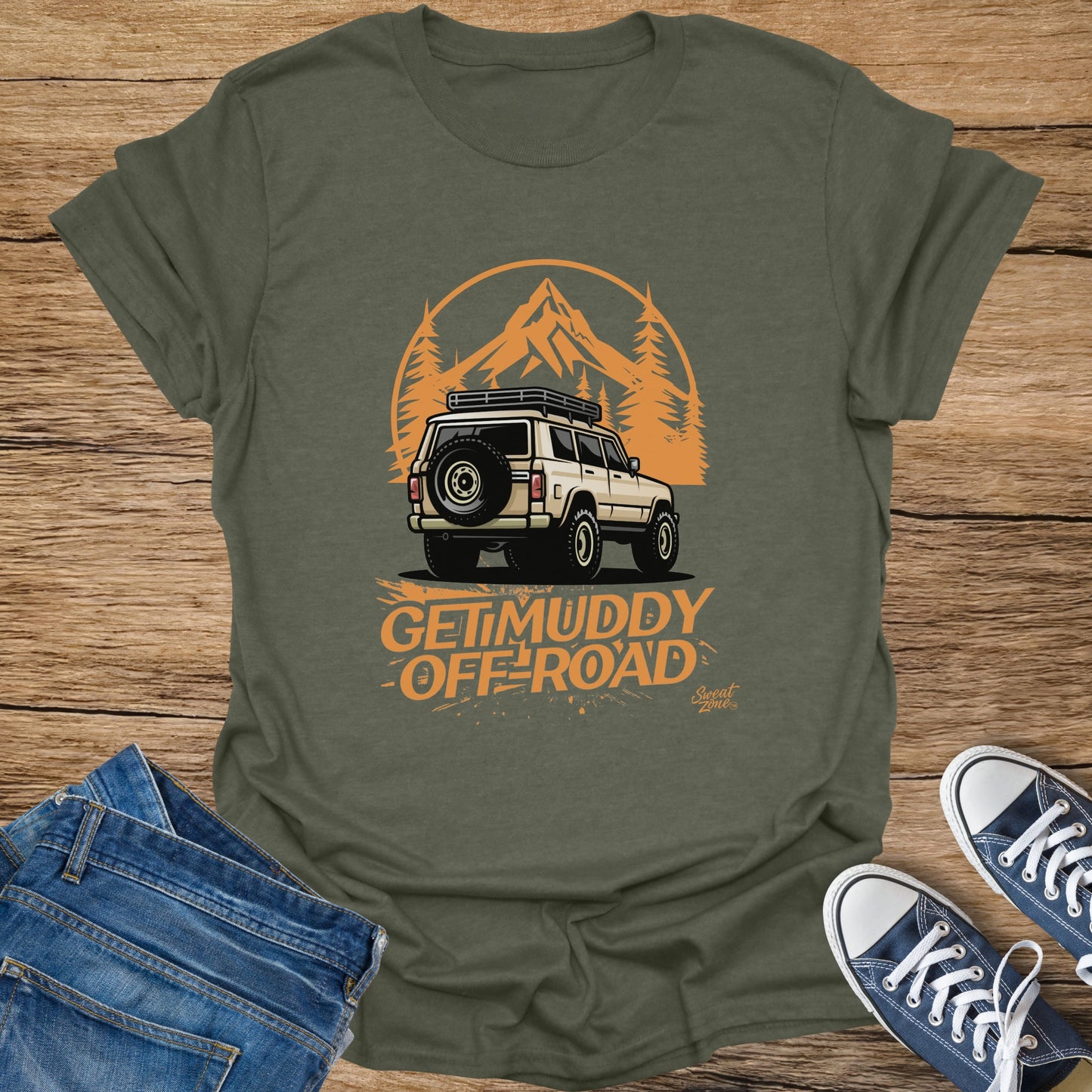 Olive green t-shirt featuring a cream off-road vehicle graphic with "GET MUDDY OFF-ROAD" text.