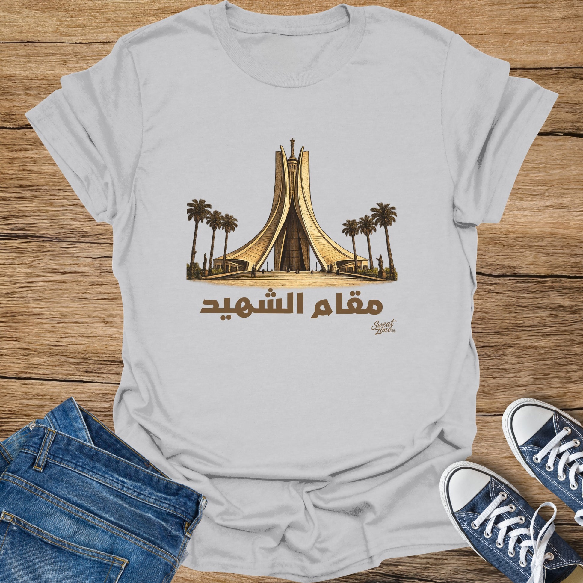 White t-shirt with a graphic of the Maqam Echouhada monument and palm trees.