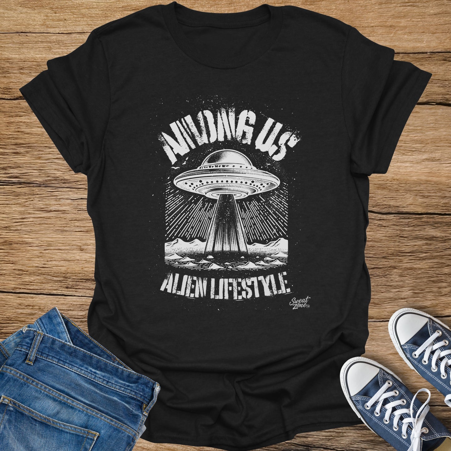 Black t-shirt with distressed white graphic of a UFO and mountains, text "Among Us".