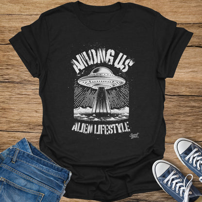 Black t-shirt with distressed white graphic of a UFO and mountains, text "Among Us".