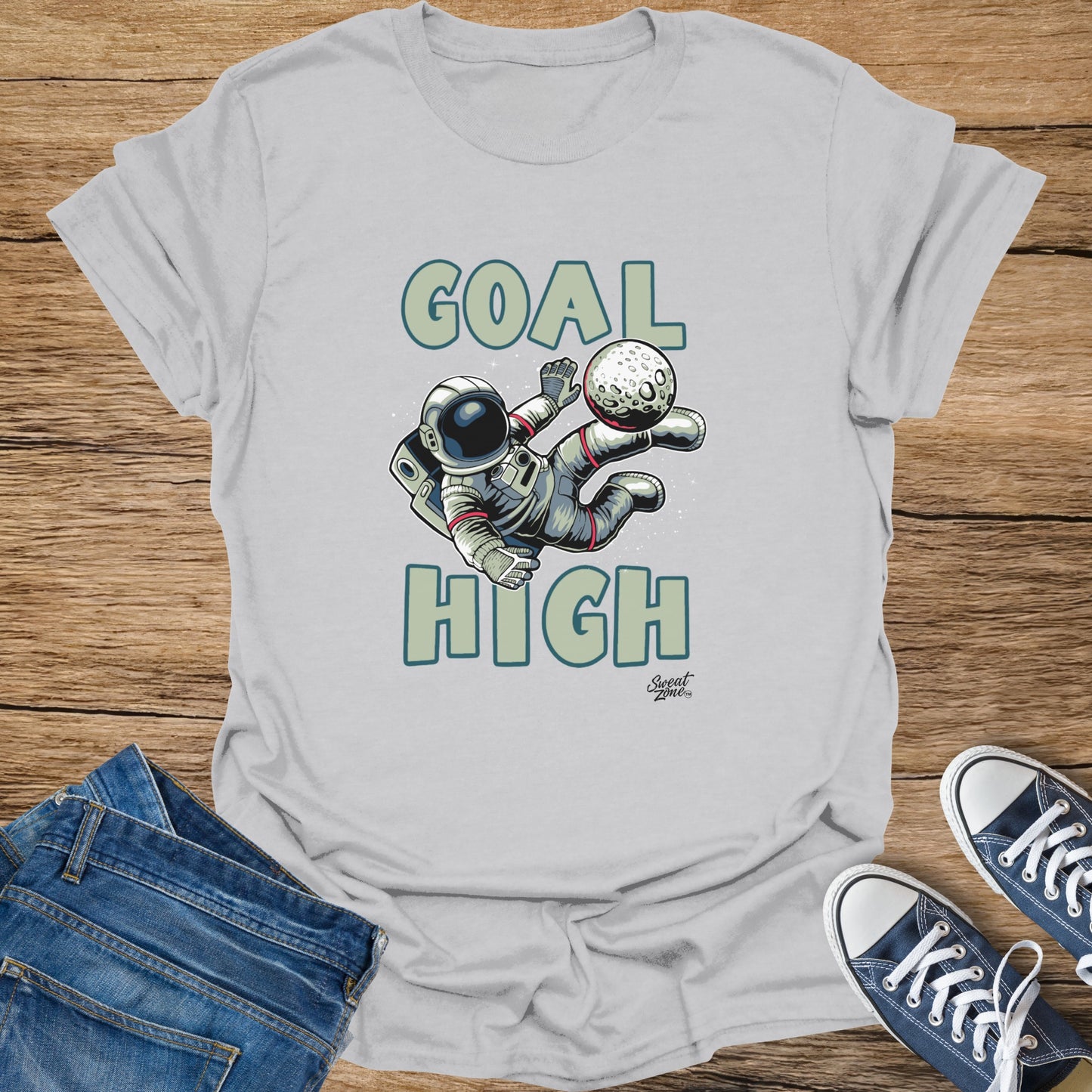 Astronaut juggling a moon with text "Goal High" and "Sweat Zone" logo.