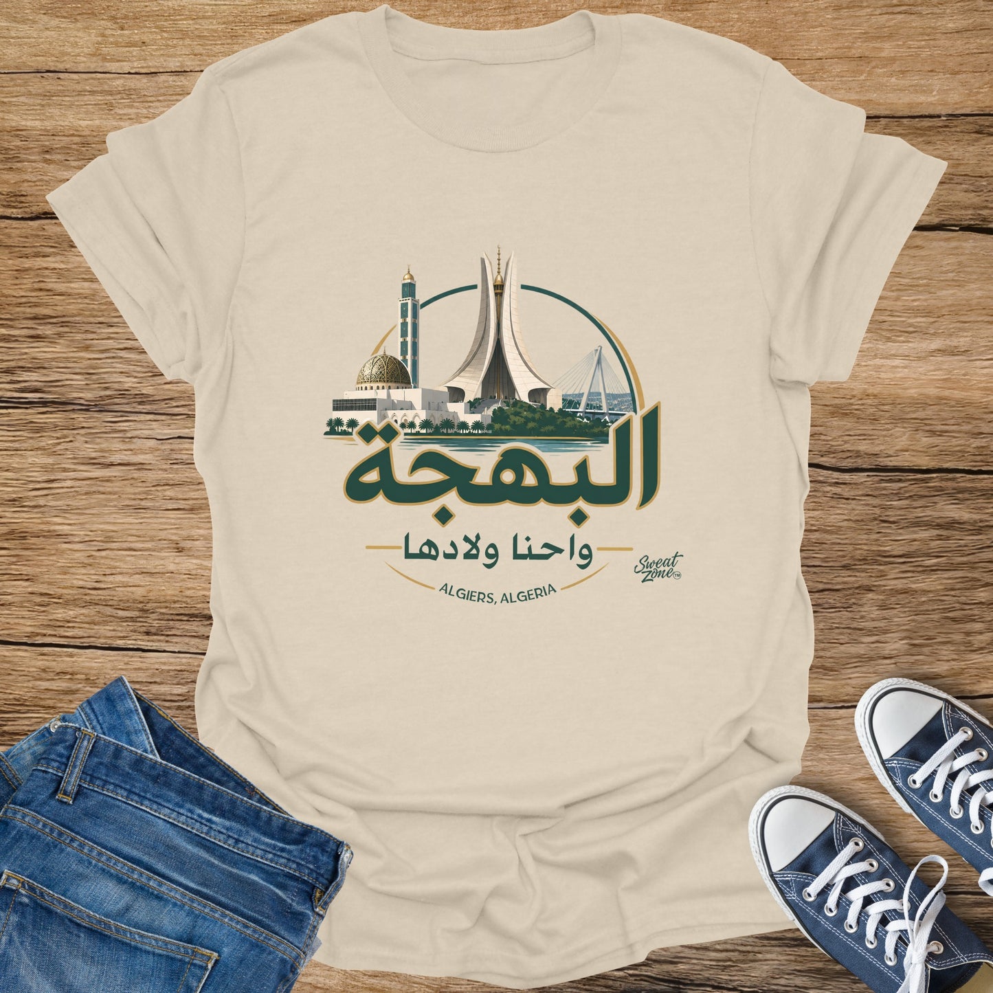Cream t-shirt with Algiers landmarks and Arabic text "Al Bahja wa Ahna Waladha".