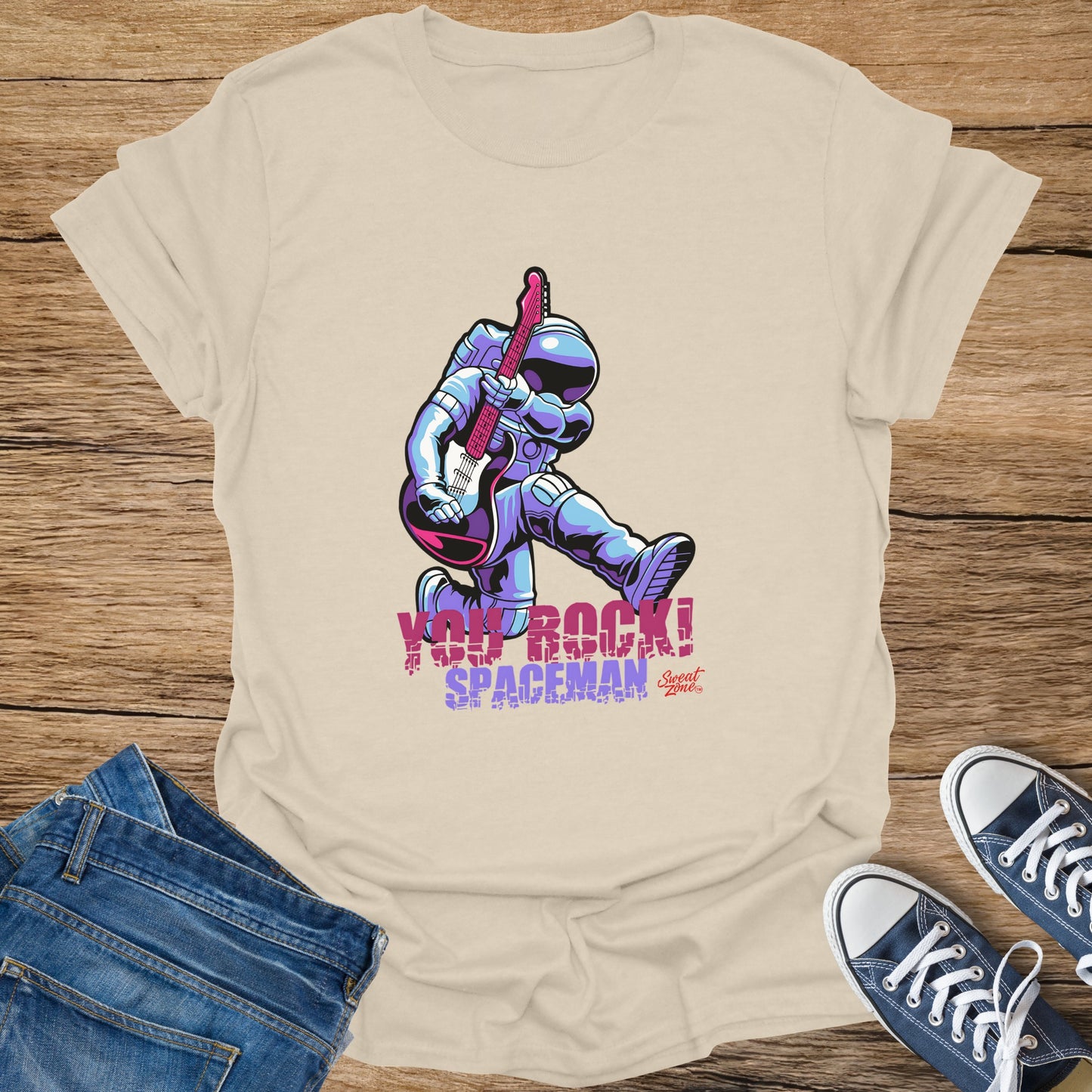 Cream t-shirt with astronaut playing guitar graphic and text "YOU ROCK! SPACEMAN".