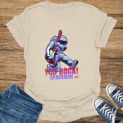 Cream t-shirt with astronaut playing guitar graphic and text "YOU ROCK! SPACEMAN".