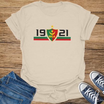 Cream t-shirt with "19 MCA 21" and a crest with yellow star and moon.