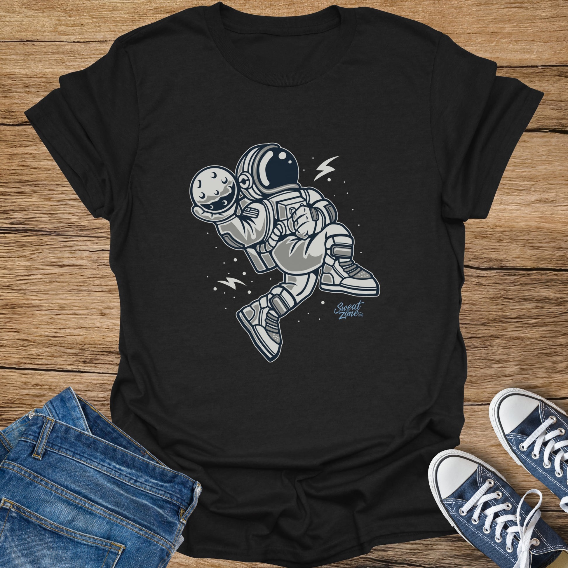 Black t-shirt with illustration of an astronaut holding the moon.