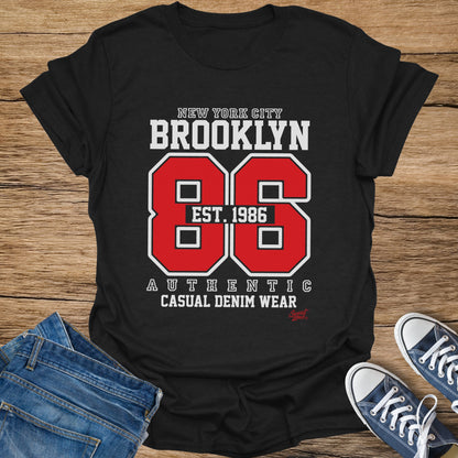 Black t-shirt with "New York City Brooklyn Est. 1986 Authentic Casual Denim Wear" graphic.